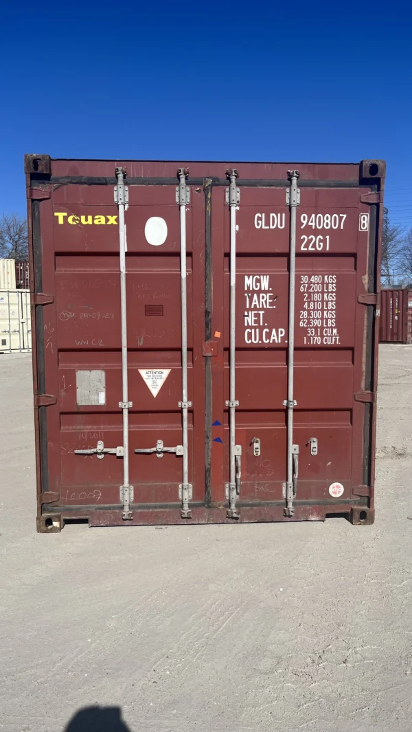 20' standard used storage container in red, front view with doors
